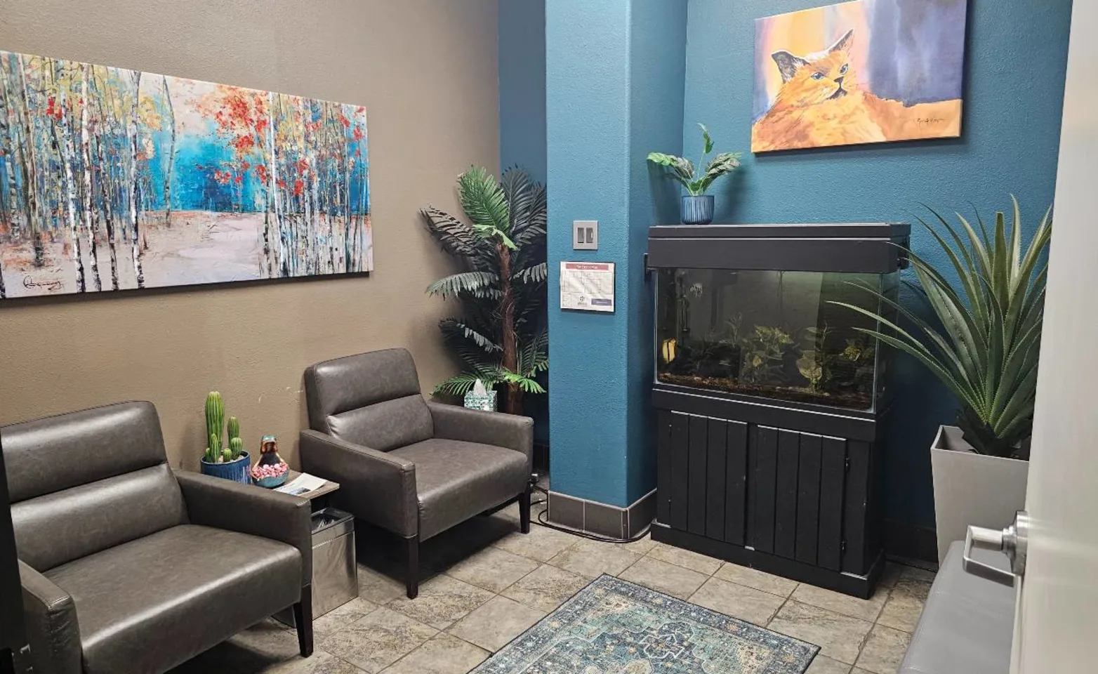 a room with a fish tank and couch at Fresno Veterinary Specialty & Emergency Center